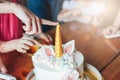 Children`s hands little girls reach for the cake. Big beautiful cake unicorn on the birthday of little Princess on festive table