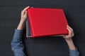 Children`s hands open a gift box with a red lid. Top view Royalty Free Stock Photo