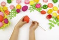 Children`s hands paint Easter eggs. The child is drawing. Easter. Royalty Free Stock Photo