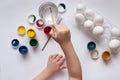 Children`s hands paint Easter eggs. The child is drawing, step by step. Royalty Free Stock Photo