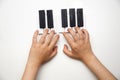 children`s hands on the piano keys, toy piano on a white background,