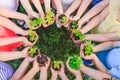 Children`s hands planting young tree on black soil together as the world`s concept of rescue. Royalty Free Stock Photo