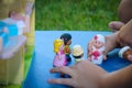 Children`s hands play toys dolls