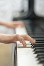 children's hands are playing the piano. Child's hand on piano keys Royalty Free Stock Photo