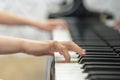 children's hands are playing the piano. Child's hand on piano keys Royalty Free Stock Photo