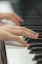 children's hands are playing the piano. Child's hand on piano keys. Royalty Free Stock Photo