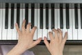 children's hands are playing the piano. Child's hand on piano keys. Royalty Free Stock Photo