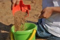 Children's hands playing with sand in a sandbox Royalty Free Stock Photo