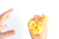 Children`s hands press homemade goo and yellow slime. White background