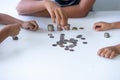 Children`s hands putting money coins to a stack of coins on the table concept: Saving money wealth and financial Personal, finance Royalty Free Stock Photo