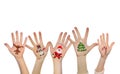 Children's hands raising up with painted Christmas symbols