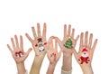 Children's hands raising up with painted Christmas symbols