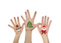 Children's hands raising up with painted Christmas symbols: Santa Claus, Christmas tree, Snow man