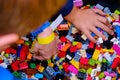 Children`s hands reach for parts to play constructor