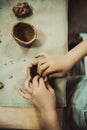 Children's hands sculpts clay