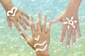 Children's hands with sea symbils