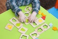 Children`s hands with a wooden sorter