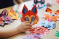 Children\'s hands working on homemade paper animal crafts