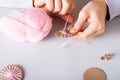 Children`s hands wrap yarn around a cardboard circle for DIY Christmas handmade decorations