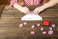 Children`s hands write a love message on Valentine`s Day. Stamps with hearts and love on the letter closeup and copy space Royalty Free Stock Photo