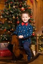 Children`s joyful memories of Christmas holidays. Santa gave a little boy a swing horse Royalty Free Stock Photo