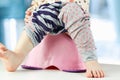 Children's legs hanging down from a chamber-pot Royalty Free Stock Photo