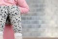 Children`s legs hanging down from a chamber-pot on a blue background Royalty Free Stock Photo