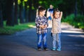 Children`s love, a little boy and a girl, having fun, laugh and smile, and kiss outdoors Royalty Free Stock Photo