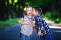 Children`s love, a little boy and a girl, having fun, laugh and smile, and kiss outdoors Royalty Free Stock Photo