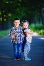 Children`s love, a little boy and a girl, having fun, laugh and smile, and kiss outdoors Royalty Free Stock Photo