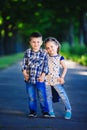 Children`s love, a little boy and a girl, having fun, laugh and smile, and kiss outdoors Royalty Free Stock Photo