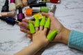 Children`s manicure. Children`s beauty salon. Paint your child`s nails with nail Polish. Nail Polish remover clips on the girl