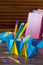 A children`s office organizer made of paper is filled with office accessories. Handmade. Royalty Free Stock Photo