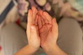 Children`s outstretched hands on a blurred background