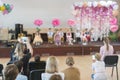 Children's party in primary school. Young children on stage in kindergarten appear in front parents. blurry