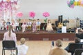 Children's party in primary school. Young children on stage in kindergarten appear in front parents. blurry