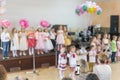 Children's party in primary school. Young children on stage in kindergarten appear in front parents. blurry. back to school