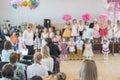 Children`s party in primary school. Young children on stage in kindergarten appear in front parents. Holiday in kindergarten.