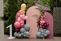 Children`s photo zone with a lot of balloons. Decorations for a One year old Girls Birthday party. Concept of children`s birthda