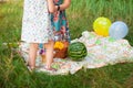Children`s picnic, watermelon on a blanket and balloons,