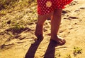 Children's pinches walk on warm sand. instagram style