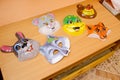 Children`s plastic masks of animals for the holiday and carnival lying on the table. hare, wolf, mouse, frog, bear, fox Royalty Free Stock Photo