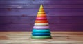 A children's play pyramid made of colorful rings. Development of fine motor skills in primary school children