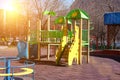Children`s playground in the courtyard of a multistory building. colorful swings and slides are installed