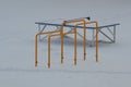 Empty ping-pong table and sports equipment in the winter outdoors in the park. Children`s playground is covered with a thick laye Royalty Free Stock Photo