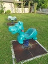 Children`s playground with cyan colored dinosaur spring toy rider Royalty Free Stock Photo