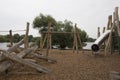 Children`s playground made of environment, eco-friendly materials. Wooden tree trunk sides, swings, net bridges, climbers. Royalty Free Stock Photo