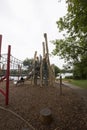 Children`s playground made of environment, eco-friendly materials. Wooden tree trunk sides, swings, net bridges, climbers. Royalty Free Stock Photo