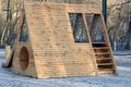 Children`s playground in the park with wooden swings and a climbing slide. Royalty Free Stock Photo