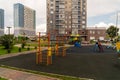 Children playground and sports ground in the courtyard of a new residential building against the background of other houses on